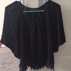 Flowy black top with crochet hem detail